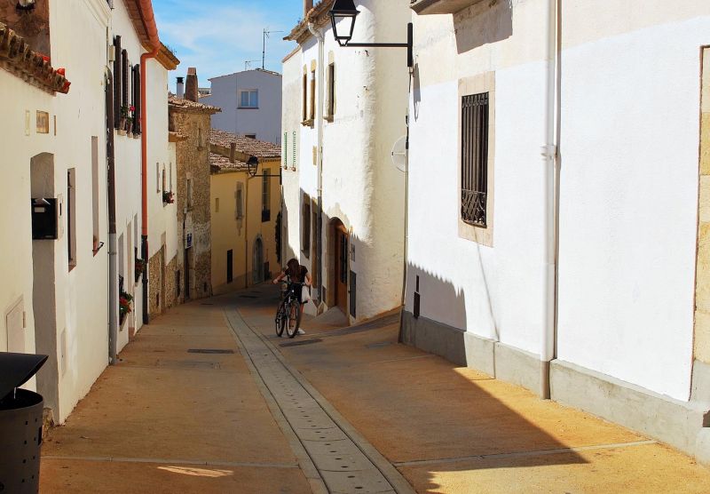 Cyclists in Girona's medieval old town streets